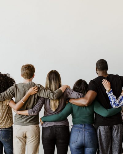 Rearview of diverse people hugging each other